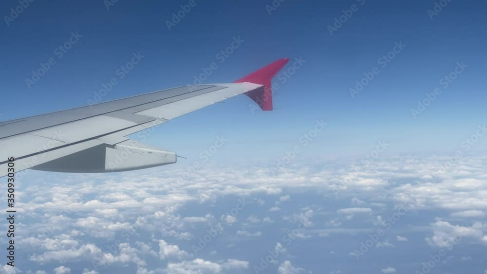 Airplane flight, clouds and wing of airplane from window of plane, air travel, Rossiya Airlines flight. Airplane flight, clouds and wing of airplane from window of plane, air travel, Rossiya Airlines flight.
