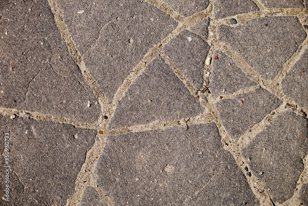 Obraz premium The texture of the broken road. Old building blocks. Background for screensaver monitor