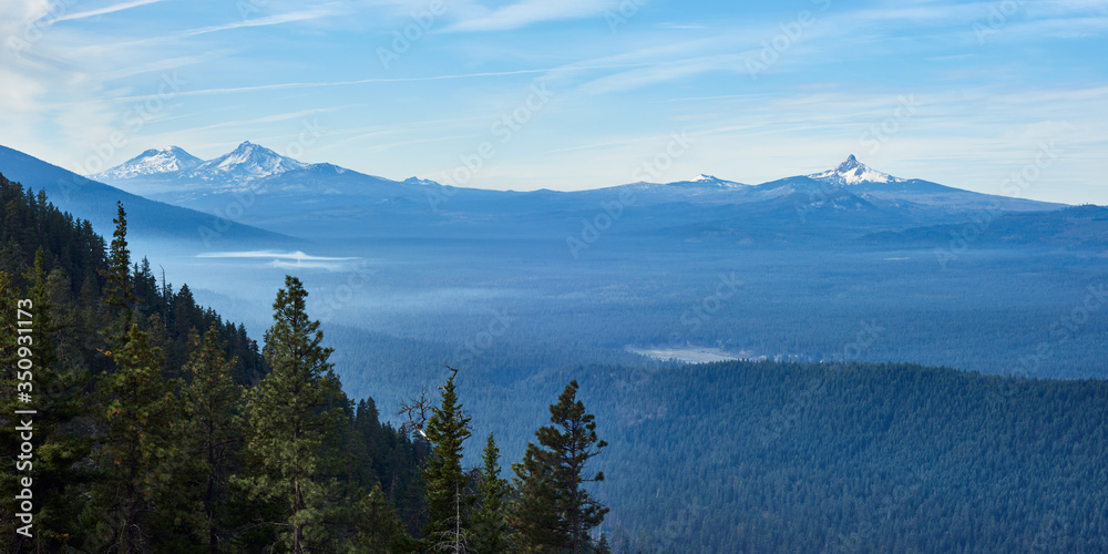 Morning panoramic view with Sisters mountains and Mt Washington from Green Ridge Lookout in central Oregon.
