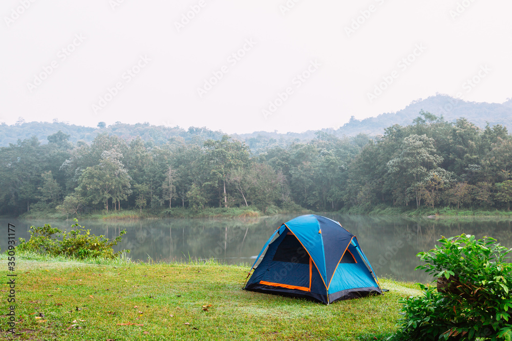 Camping tent by a lake with mist at sunrise Jetkod-Pongkonsao Natural Study in Saraburi Thailand	