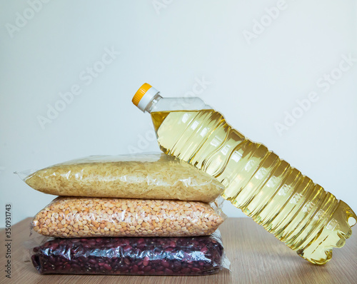 cereals in a package, and sunflower oil in a bottle, lying on the kitchen table