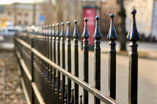 Metal bars of a fence in a row.