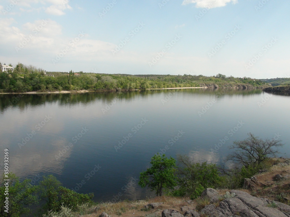 Panorama of the old channel of the Dnieper that reflects on its mirror surface a cloudy blue sky. Panorama of the old channel of the Dnieper that reflects on its mirror surface a cloudy blue sky.