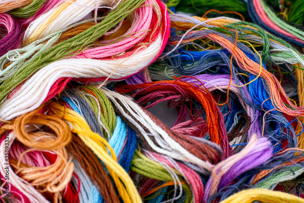 Heap of multi colored embroidery threads.