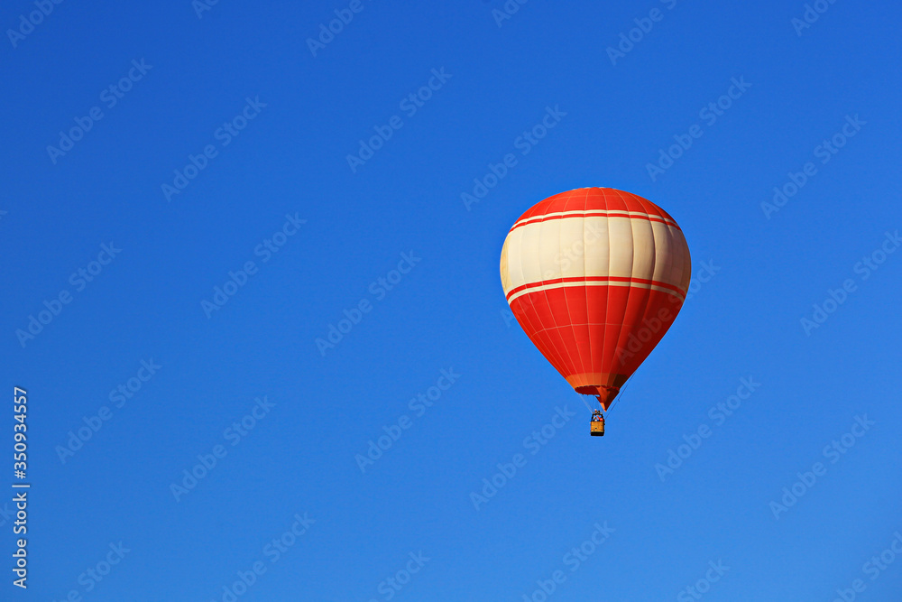 A red balloon floats on blue sky background in Vang Vieng, Laos A red balloon floats on blue sky background in Vang Vieng, Laos