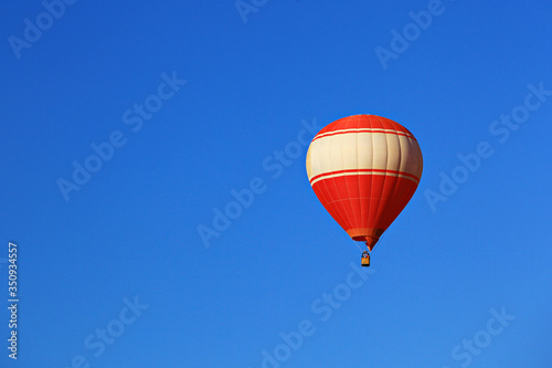 A red balloon floats on blue sky background in Vang Vieng, Laos