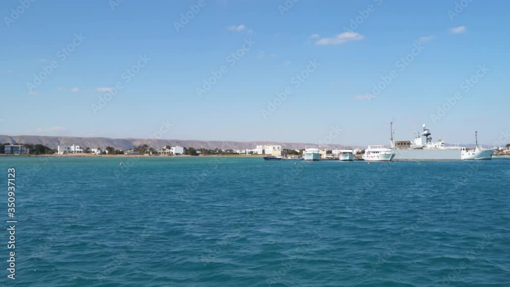 Yachts on the pier. The coast of the Red Sea in Egypt. View from a floating ship Yachts on the pier. The coast of the Red Sea in Egypt. View from a floating ship