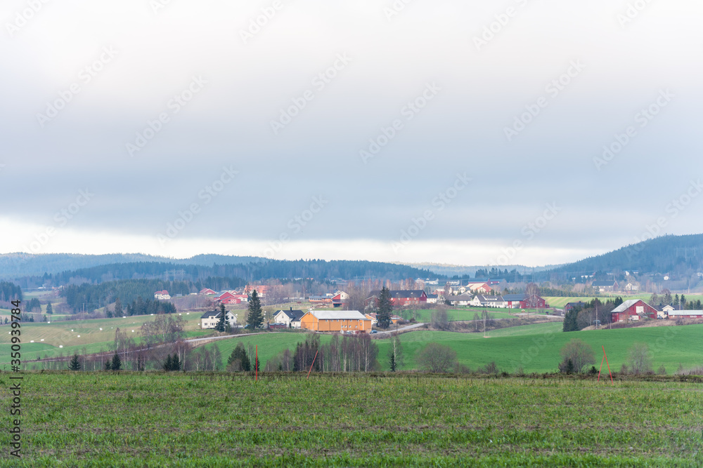 Beautiful house and green field in a Norwegian village in a winter at Skjetten, in the Skedsmo, a municipality in Akershus county, Norway. Beautiful house and green field in a Norwegian village in a winter at Skjetten, in the Skedsmo, a municipality in Akershus county, Norway.