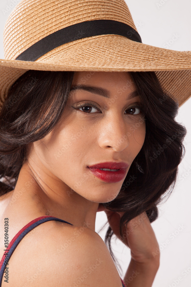 Lovely woman in a straw hat looking thoughtful Lovely woman in a straw hat looking thoughtful
