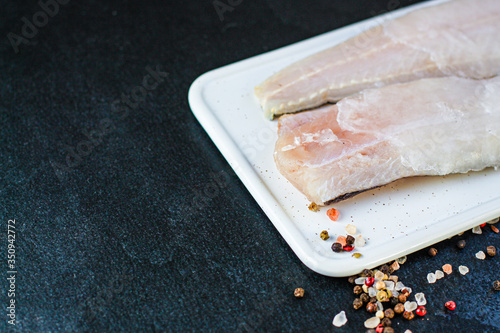 raw fish frozen ice fillet hake Menu concept healthy eating. food background top view copy space for text healthy eating ketogen or paleo diet, pascarian