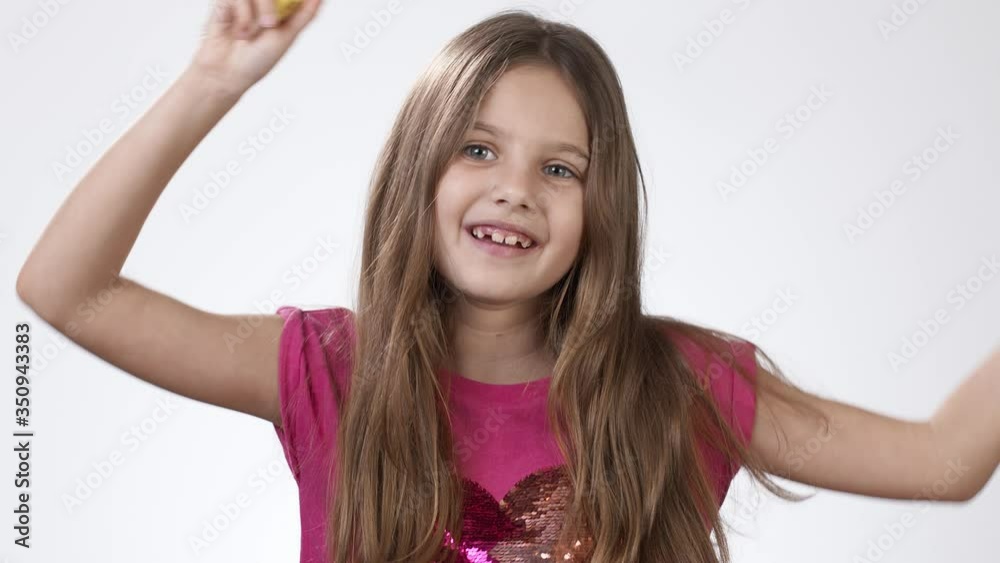 Girl dances with a banana. A girl peels a banana and eats a banana. Happy emotions of a hungry girl who was eating a banana.