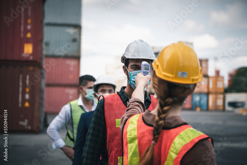 Coronavirus Covid-19 Disease Epidemic Crisis Situation, Construction Worker Having Fever Body Scan by Thermometer Scanning at Construction Site. Corona-Virus Covid19 Prevention of New Normal Concept