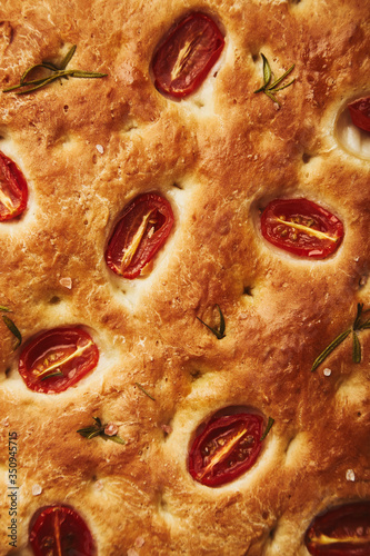 Italian pastries with cherry tomatoes and spicy herbs -focaccia