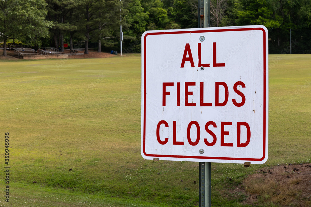 All Fields Closed sign by an empty soccer field, coronavirus shutdown of sports, horizontal aspect All Fields Closed sign by an empty soccer field, coronavirus shutdown of sports, horizontal aspect