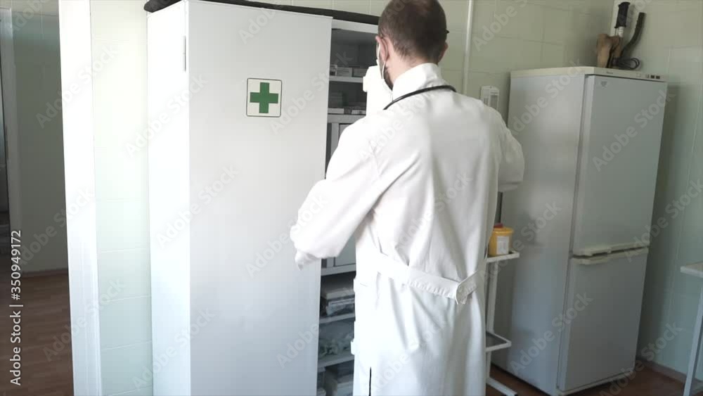 doctor in the laboratory opens a drawer with medicament doctor in the laboratory opens a drawer with medicament