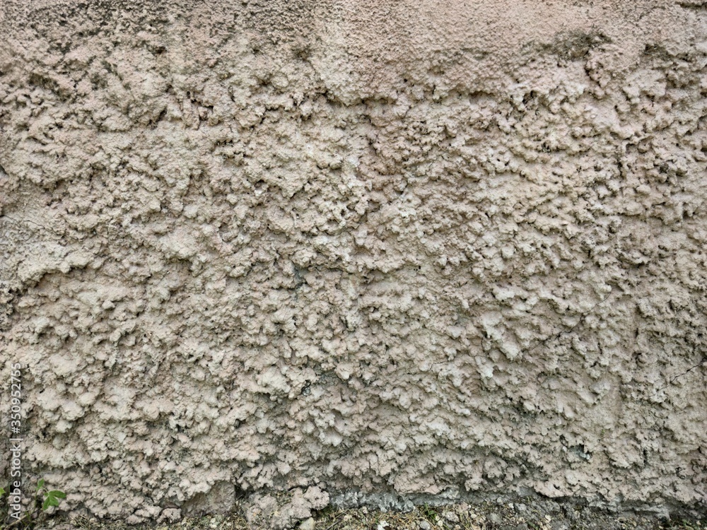 Naklejka premium Wall of gray concrete with high pimples.