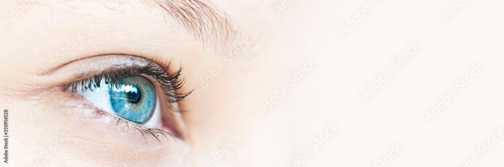Close up on a girl blue eye, panoramic web banner with copy space - obrazy, fototapety, plakaty 
