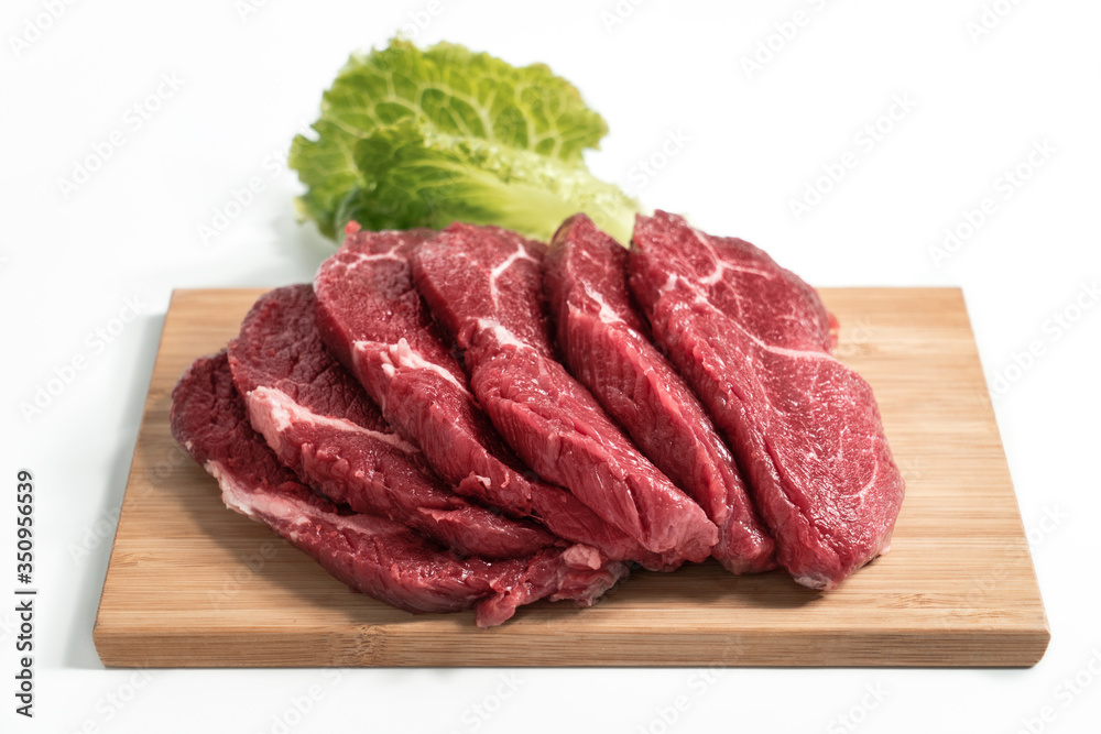 Freshness raw beef in pieces on the cutting board with white background.