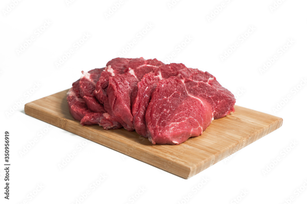 Freshness raw beef in pieces on the cutting board with white background.
