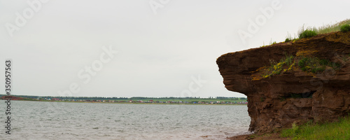 rock above the lake in cloudy weather