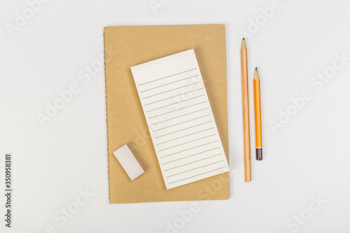 stack of colorful notebooks with pen isolated on white background