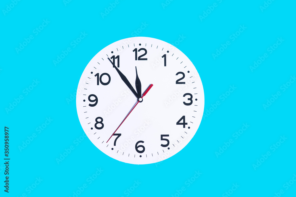 White clock on a blue background and place for text White clock on a blue background and place for text