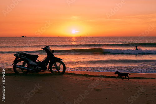 Biker on sunrise beach beautiful view