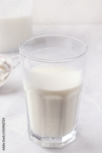 Fermented kefir in a glass on a white background. Dairy Products. Vertical Image