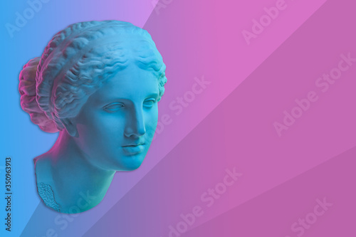 Statue of Venus de Milo. Creative concept colorful neon image with ancient greek sculpture Venus or Aphrodite head. Webpunk, vaporwave and surreal art style. Pink and blue duotone effects.