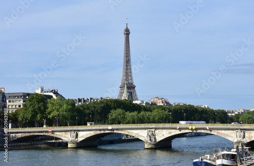 Tour Eiffel and Pont des Invalides with the Seine River on a sunny day. Paris, France.