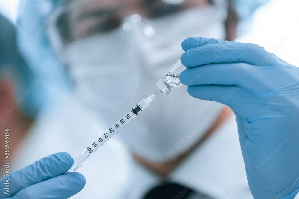 close up. scientist filling the syringe with the new vaccine . close up. scientist filling the syringe with the new vaccine .