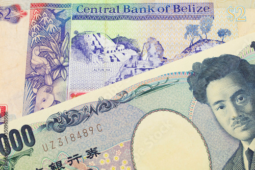 A macro image of a Japanese thousand yen note paired up with a colorful two dollar bill from Belize. Shot close up in macro.