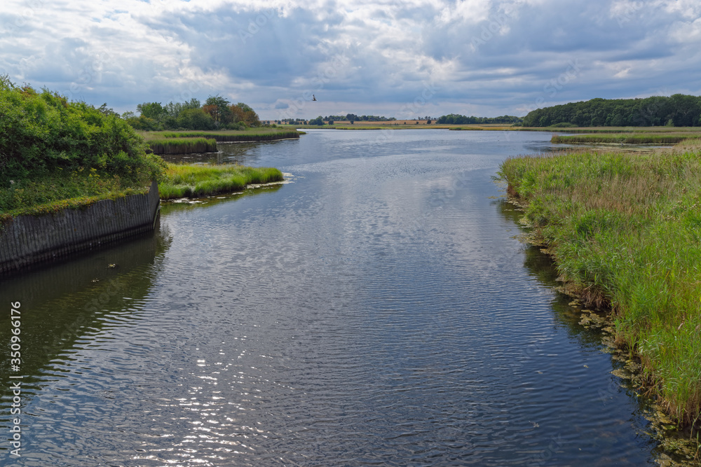 beautiful panoramic view of the lake on summer day against cloudy sky. Heiligenhafen in Northern Germany