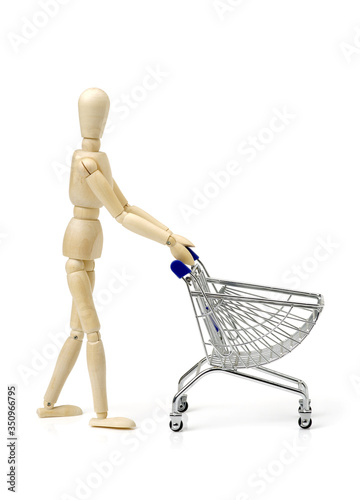 Shopping concept. Wooden doll and metal shopping cart © zcy