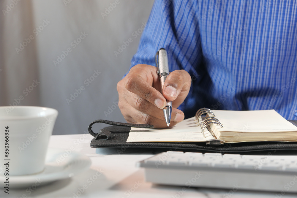Close up of person hand writing on notepad. Close up of person hand writing on notepad.