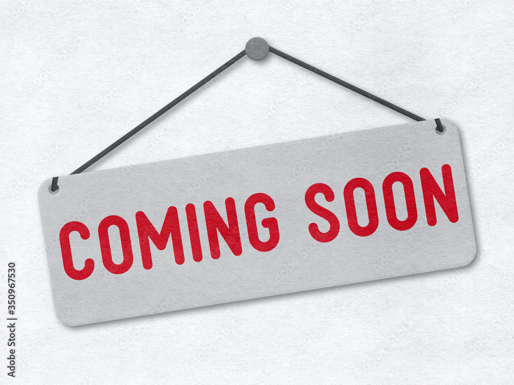 Coming soon - signboard on a paper background Coming soon - signboard on a paper background