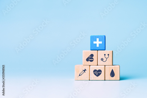 Принти на полотні Health insurance concept, wooden blocks with healthcare medical icons on blue ba