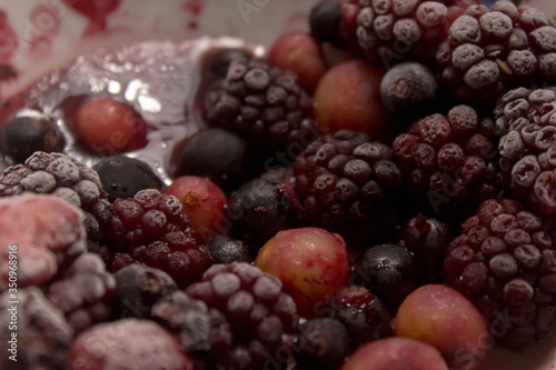 Frozen berries on a plate. Summer fresh berries. Selective focus.