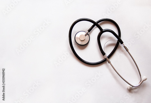 Phonendoscope on a white background in the shape of a heart and infinity