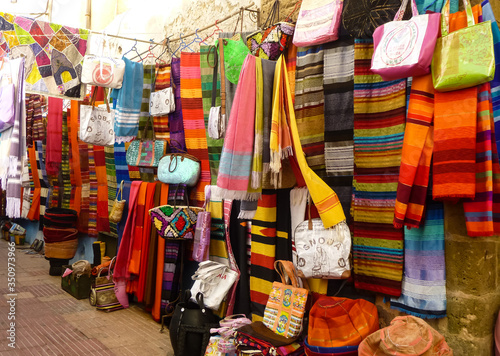 Market with colourful bags and scarves © Chrissie