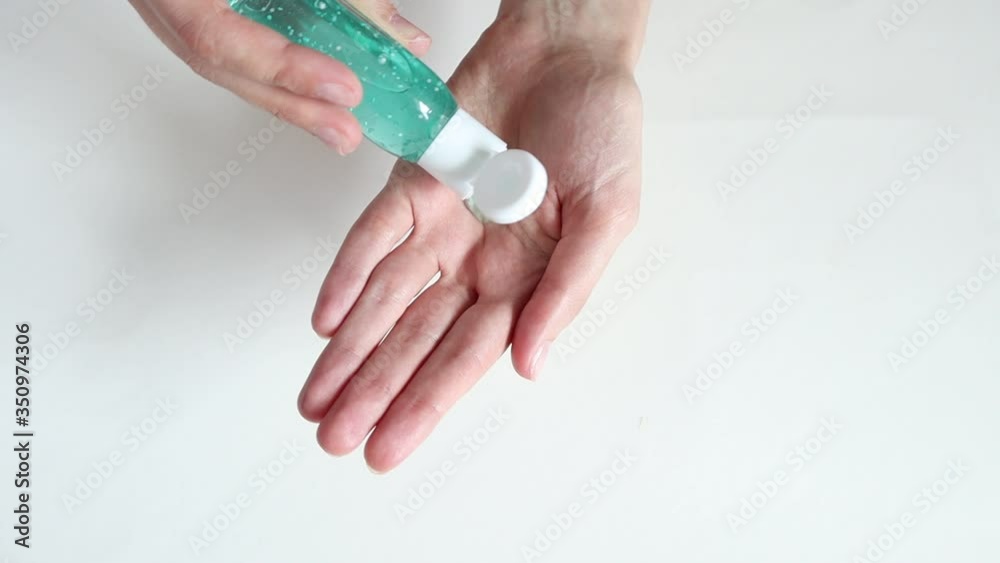 Closeup of woman`s hands using an alcohol antibacterial hand sanitizer. Clean hands hygiene corona virus prevention. Closeup of woman`s hands using an alcohol antibacterial hand sanitizer. Clean hands hygiene corona virus prevention.