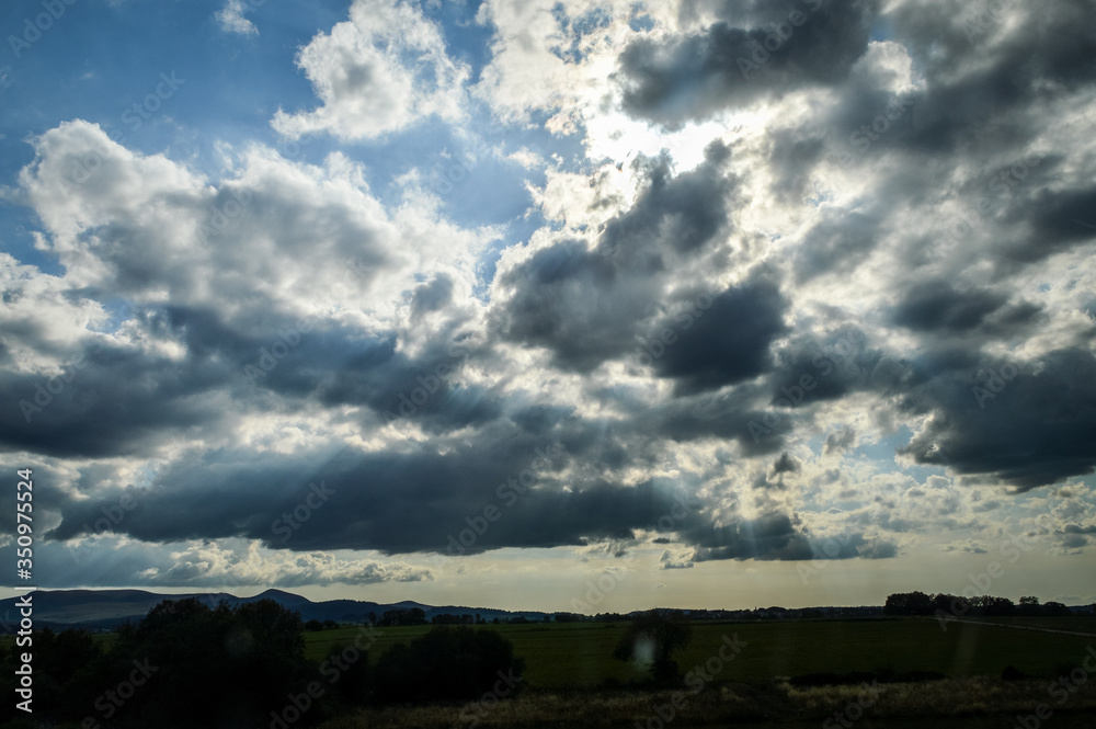 Beautiful cloudy sky at sunset in the french countryside - background