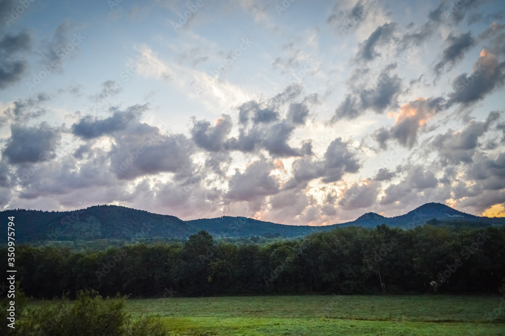 Beautiful sunrise with clouds in Auvergne regional area. Puy de Dome - the heart of the Massif Central, Auvergne-Rhone-Alpes, France.