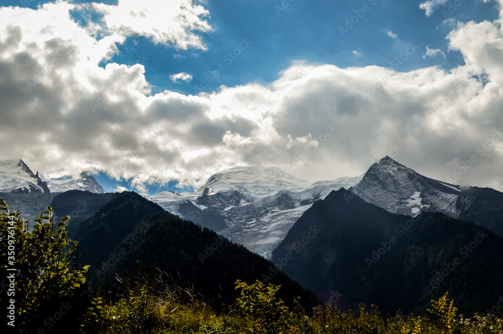 French Alps mountains in a cloudy summer day, seen from Chamonix, Haute Savoy, France.