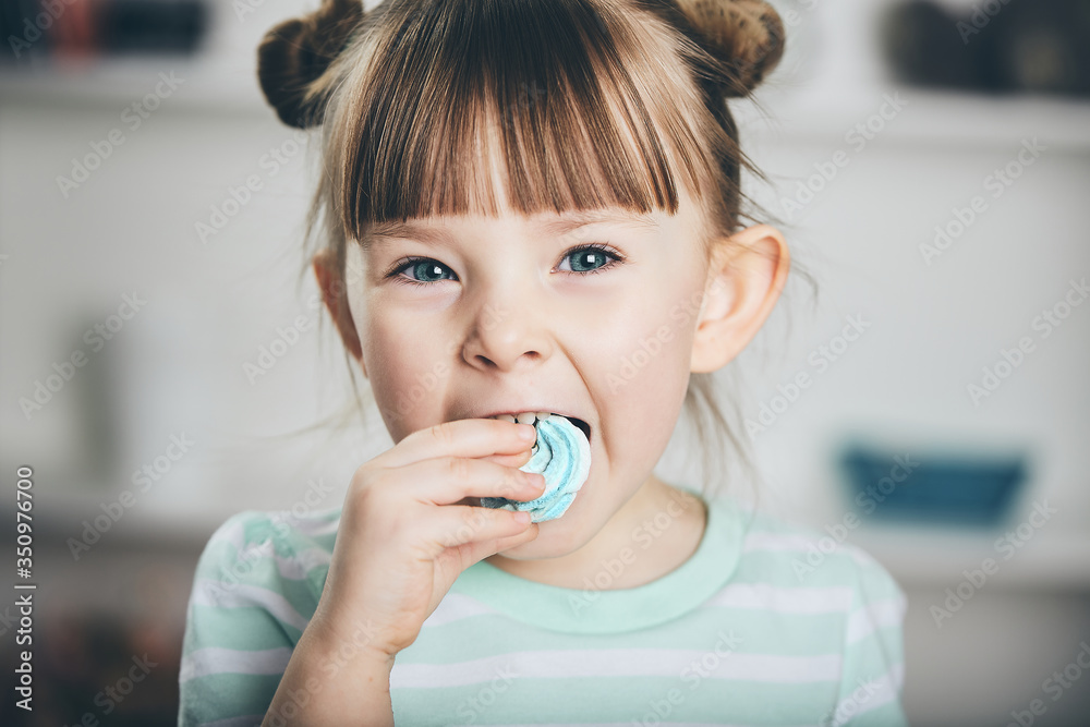 Nice little girl eats merengue. Nice little girl eats merengue.
