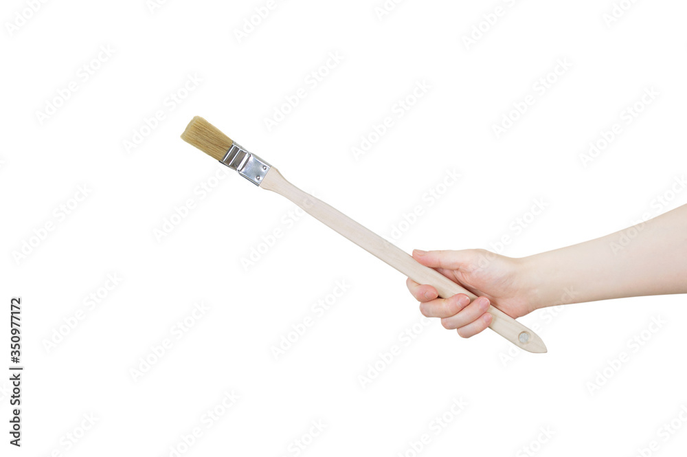 Brush for painting radiators in the hand of caucasian woman. White isolate. Brush for painting radiators in the hand of caucasian woman. White isolate.