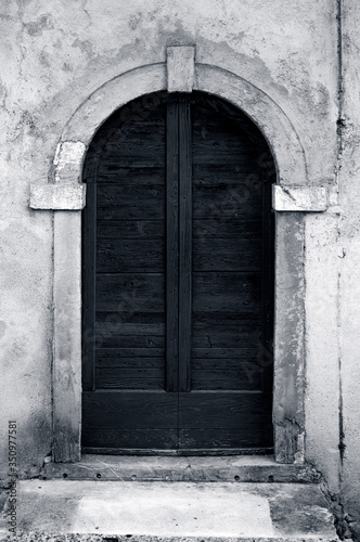 Vintage wooden door in black and white colors.