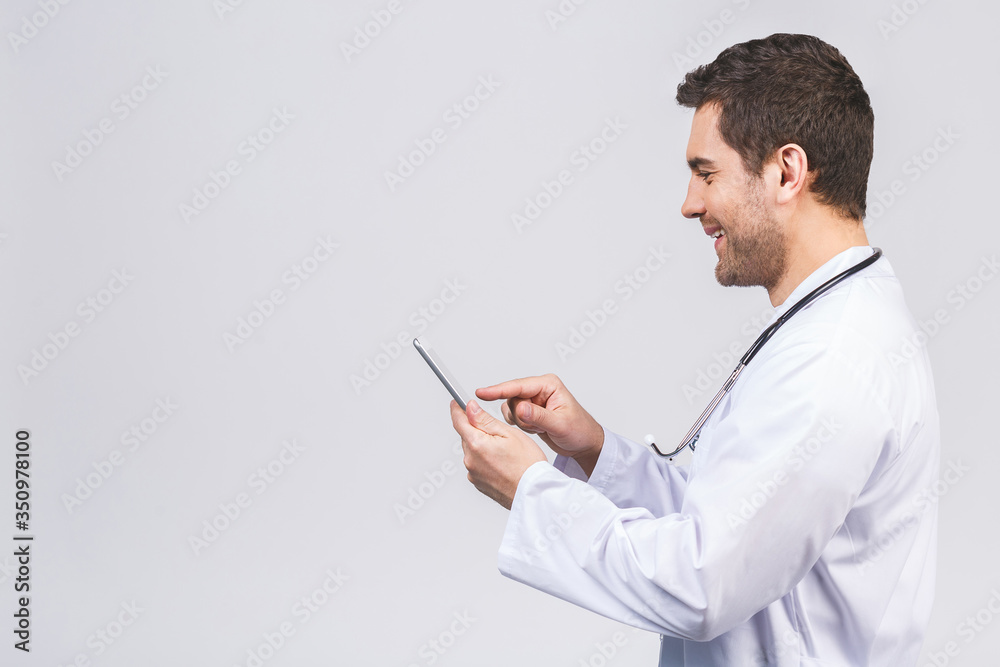 Portrait of a cheerful smiling medical doctor or nurse with stethoscope using pc tablet computer isolated on white background. Portrait of a cheerful smiling medical doctor or nurse with stethoscope using pc tablet computer isolated on white background.