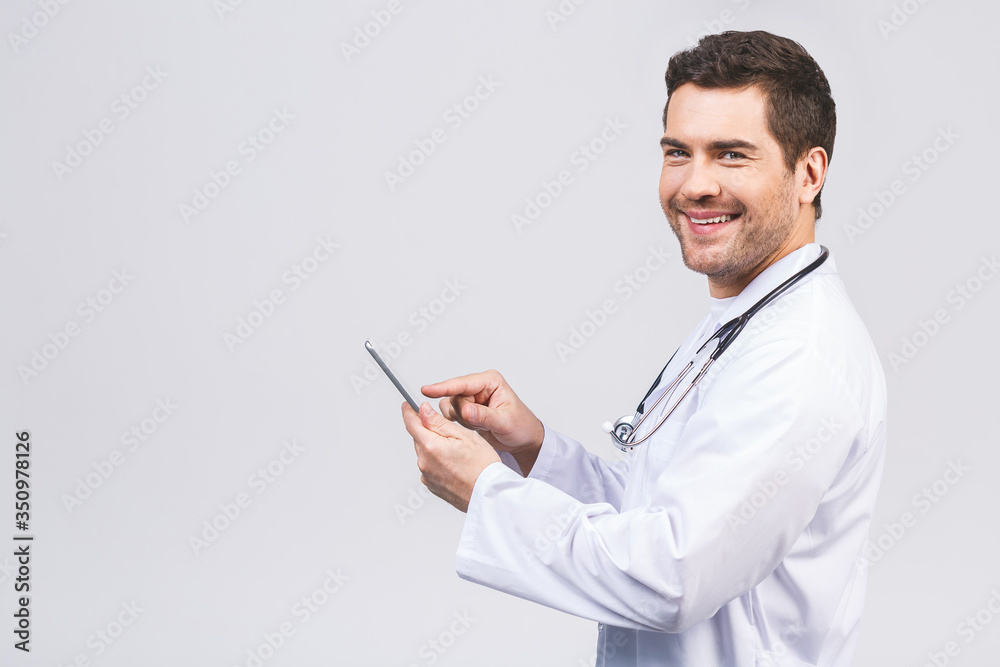 Portrait of a cheerful smiling medical doctor or nurse with stethoscope using pc tablet computer and looking at camera isolated on white background. Portrait of a cheerful smiling medical doctor or nurse with stethoscope using pc tablet computer and looking at camera isolated on white background.