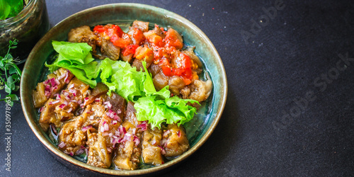 eggplant salad spices and tomatoes, antipasto Menu concept healthy eating. food background top view copy space for text keto or paleo organic